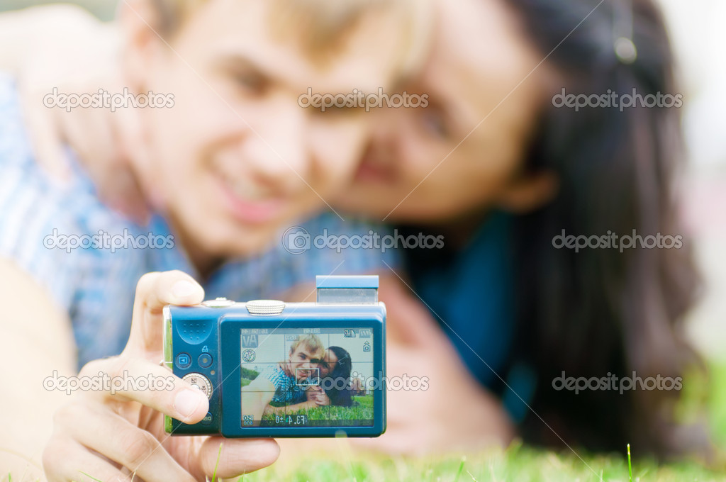 Happy teenage couple taking picture