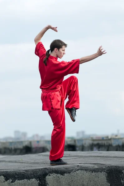 Wushoo hombre en las artes marciales práctica rojo — Stockfoto