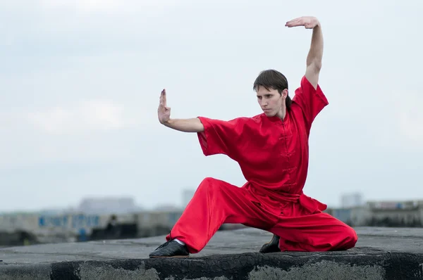 Wushoo hombre en las artes marciales práctica rojo — Stockfoto