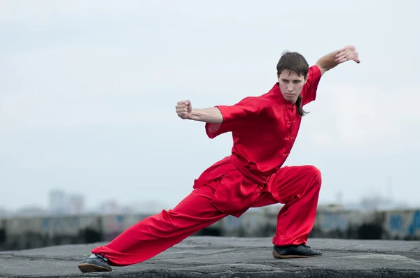 Wushoo hombre en las artes marciales práctica rojo — Stockfoto