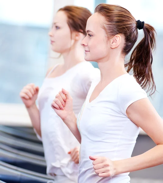 Deux jeunes femmes sportives courent sur la machine — Photo