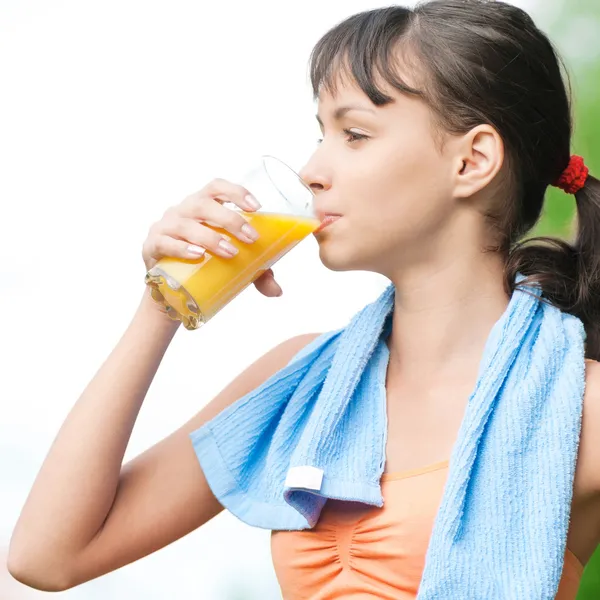 Girl drinking juice after exercise — Stock Photo, Image