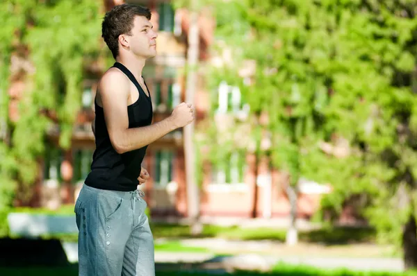 Young man jogging in park — Stock Photo, Image