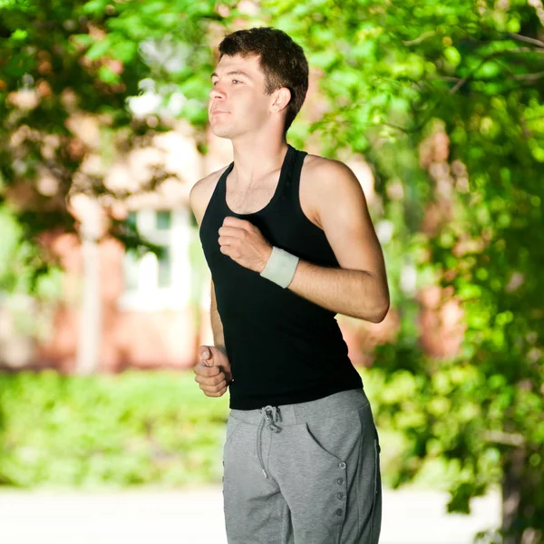 Young man jogging in park — Stock Photo, Image