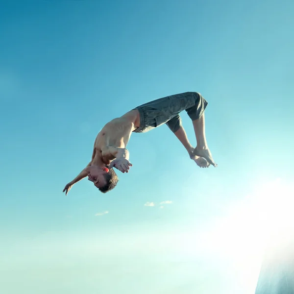 Excited young man jumping in air — Stock Photo, Image