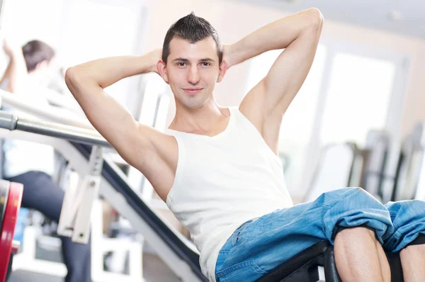 Young man doing exercises at gym — Stock Photo, Image