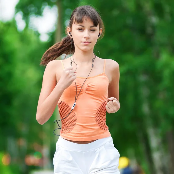 Teenage girl running in green park Stock Image