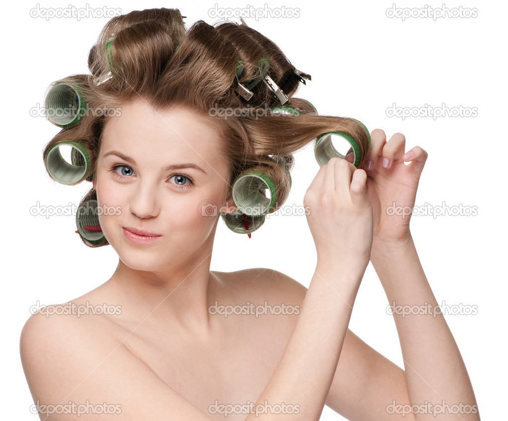 woman curling her hair with roller