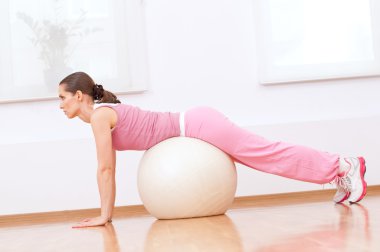 Woman doing stretching exercise on ball
