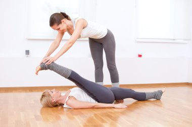 Women doing yoga exercise at gym