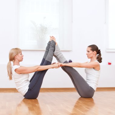 Women doing yoga exercise at gym