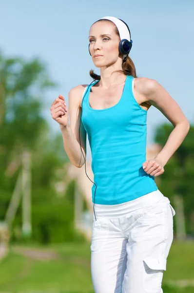 Hermosa mujer corriendo en el parque verde — Foto de Stock