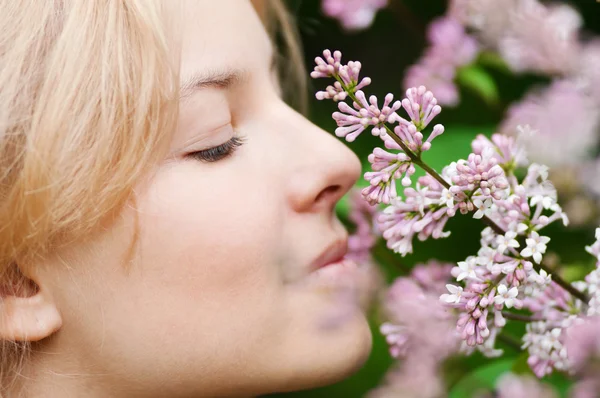 Woman with lilac flower on face Stock Photo