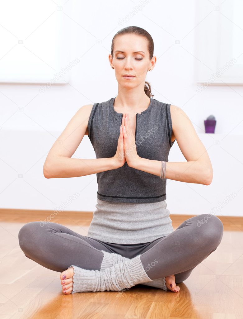 Woman doing stretching yoga exercise at sport gym — Stock Photo