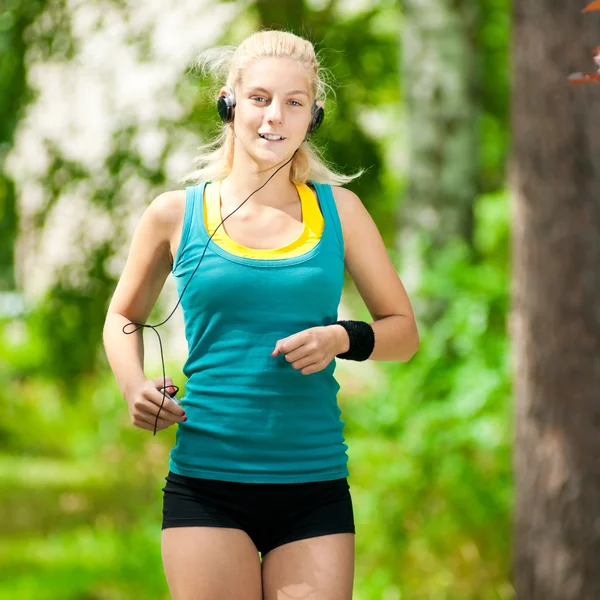 Beautiful young woman running on music Royalty Free Stock Images