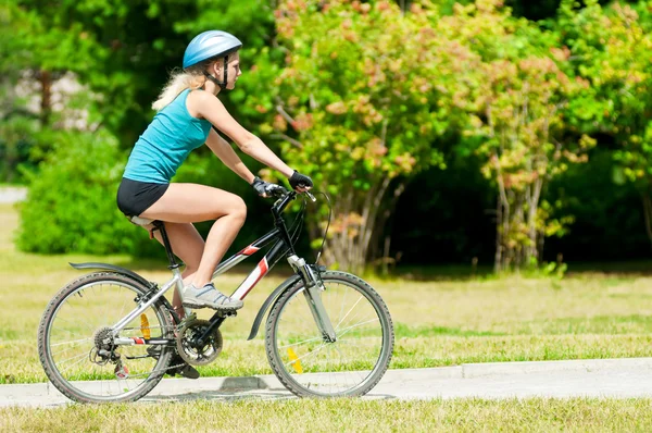 Young smiling woman on bike Stock Photo