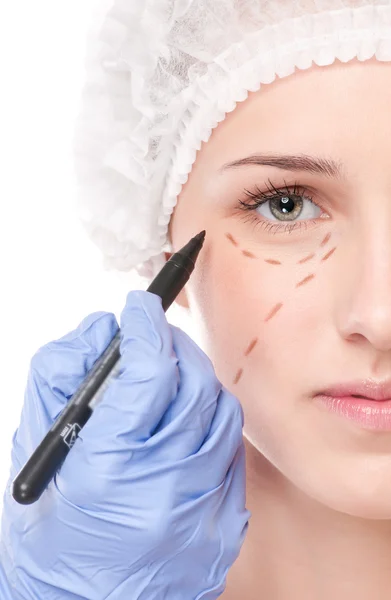 Beautician draw correction lines on woman face — Stock Photo, Image