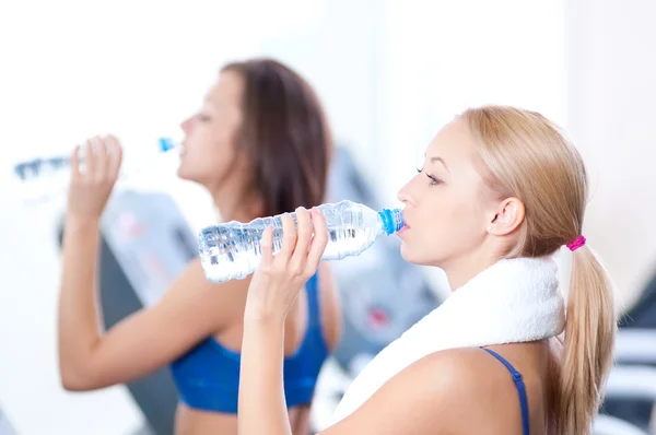 Women drinking water after sports