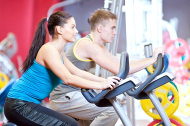 insanlar Bisiklete binme kardiyo egzersizi yaparken spor salonunda