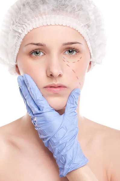 Beautician draw correction lines on woman face — Stock Photo, Image