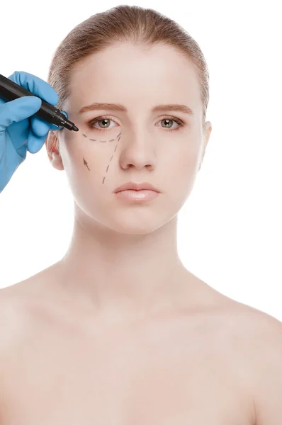 Beautician draw correction lines on woman face — Stock Photo, Image