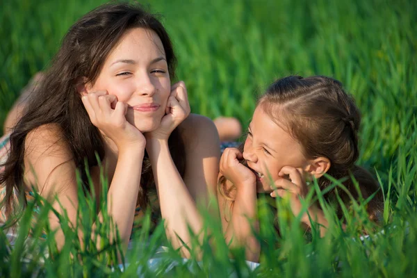 Happy girls on green grass — Stock Photo, Image