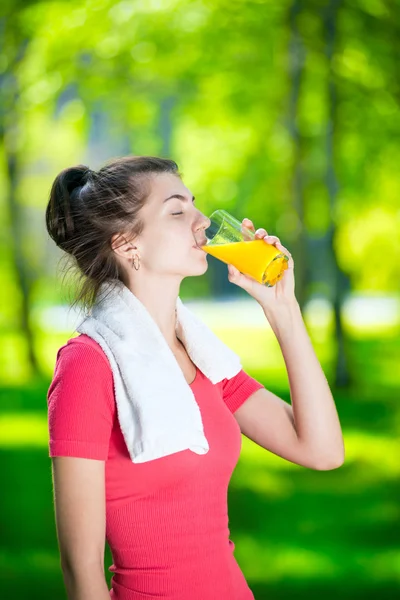 Mulher bebendo suco de laranja fresco — Fotografia de Stock