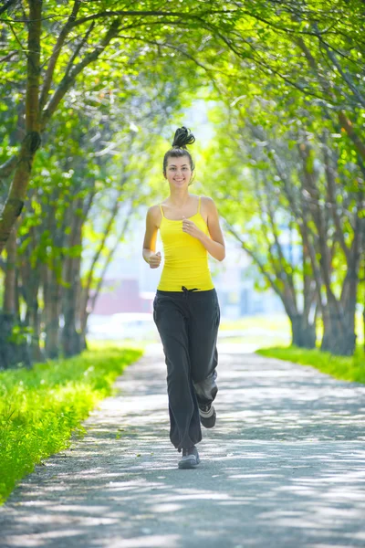 Runner - woman running outdoors in green park — Stock Photo, Image