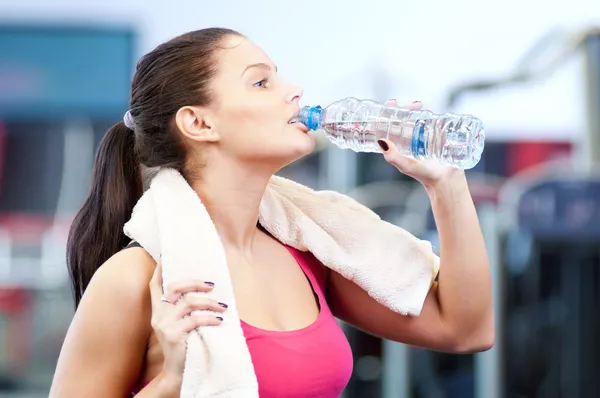 Man and woman drinking water after sports — Stock Photo, Image