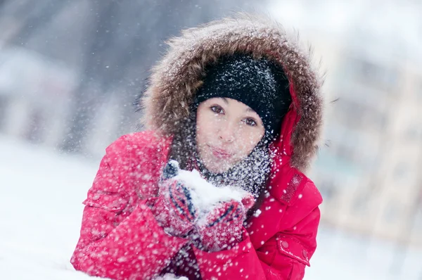 Happy young woman plays with a snow Stock Image
