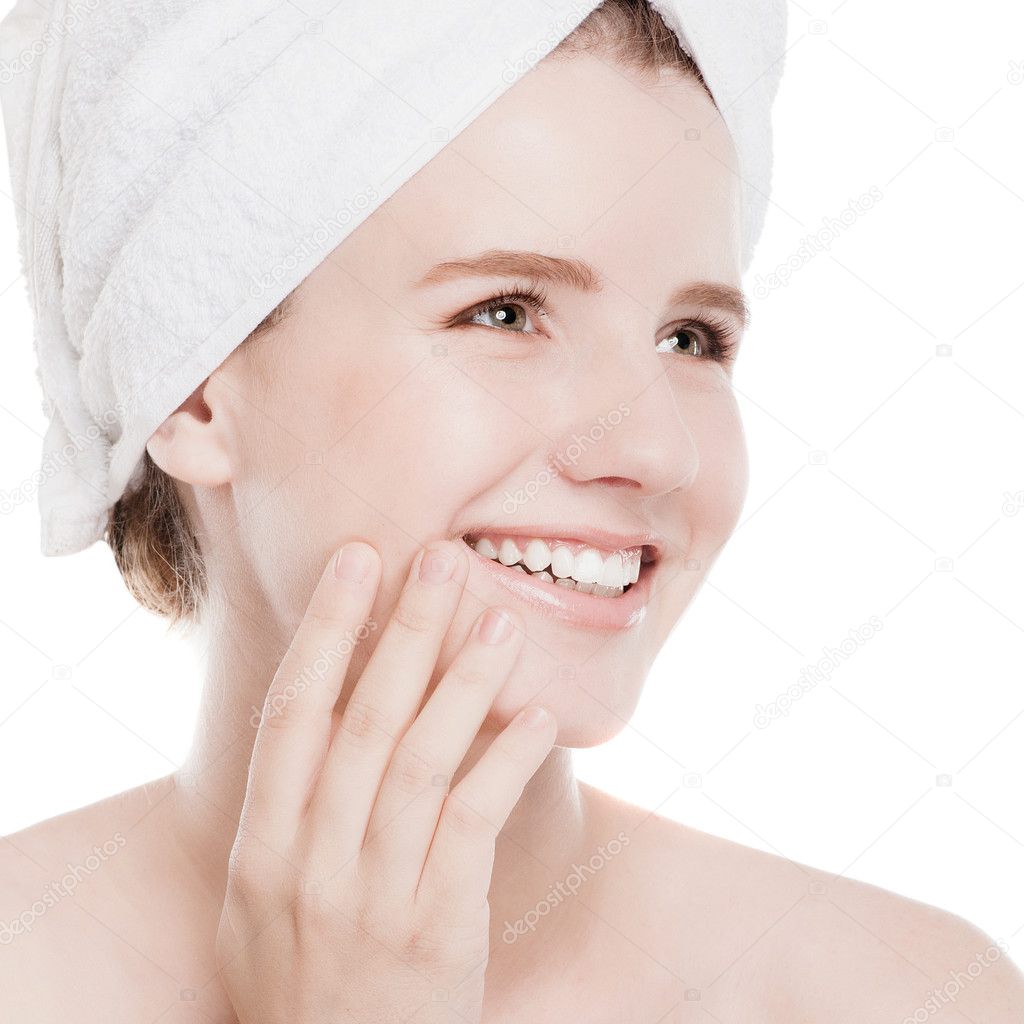 Woman applying moisturizer cream on face