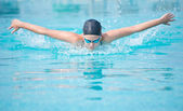 Fiatal lány pillangó körvonalstílus úszás