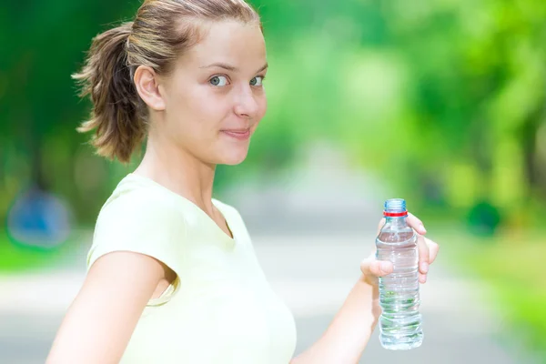 Woman drinking mineral water — Stock Photo, Image