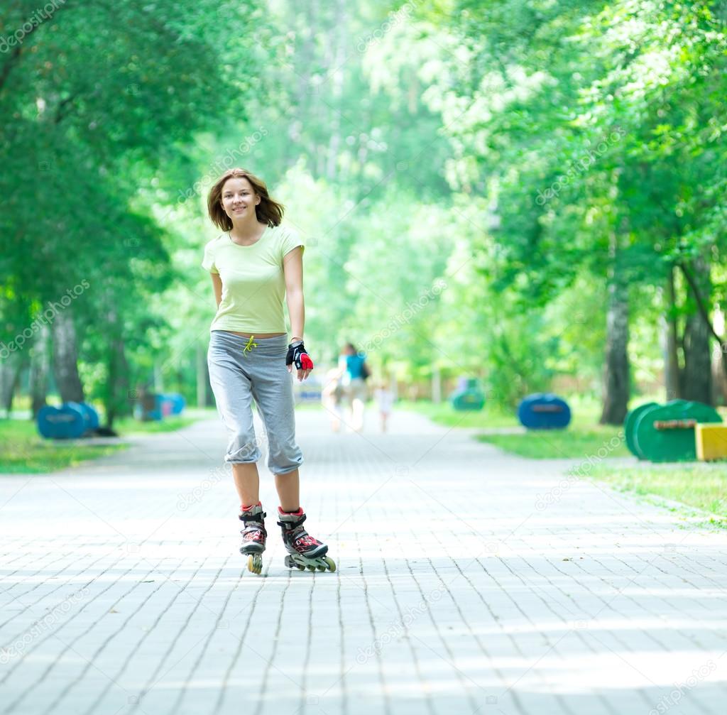 Roller skating sporty girl in park