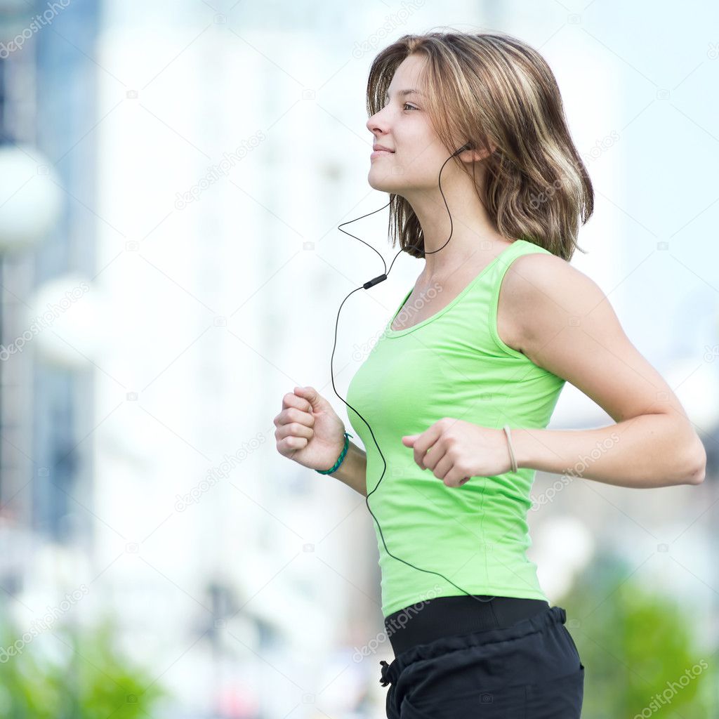 Woman jogging in city street park