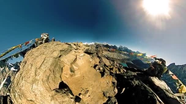 360 VR Gokyo Ri mountain top. Tibetan prayer Buddhist flag. Wild Himalayas high altitude nature and mount valley. Rocky slopes covered with ice. Tiny planet transformation. — Stock Video