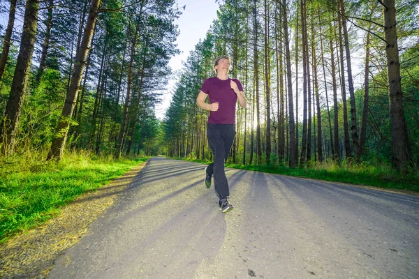 Mężczyzna jogging w mieście partk w piękny letni dzień. Sport fitness model kaukaski etniczność trening outdoor. — Zdjęcie stockowe