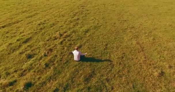 Aerial View Point Low Orbital Flight Man Seated Green Grass — Stock Video