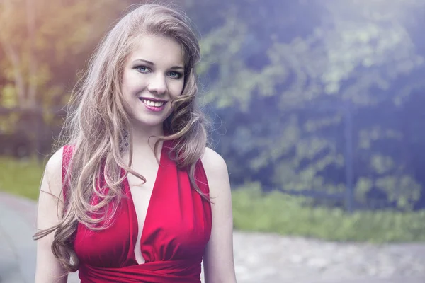 Pretty young woman in red dress — Stock Photo, Image