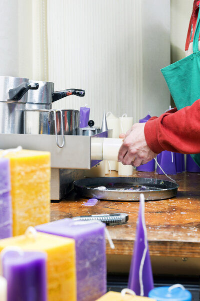 Candle maker at work in a chandler