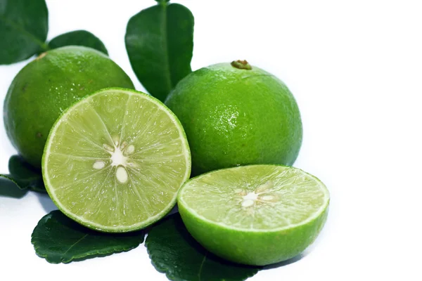 Limes with slices and leaves — Stock Photo, Image