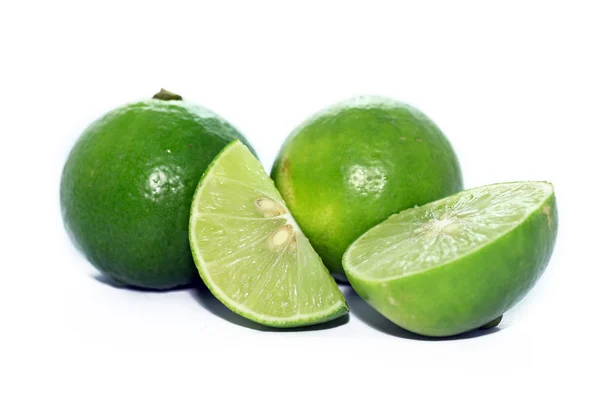 Limes with slices and leaves — Stock Photo, Image