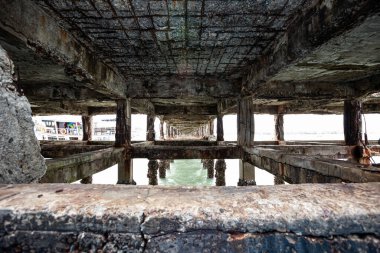 under the pier by the sea