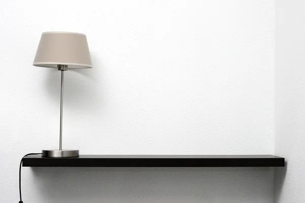 Shelf on the wall with lamp — Stock Photo, Image