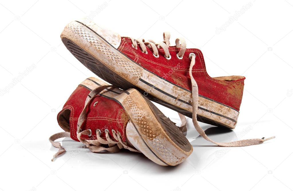 a pair of dirty sneakers isolated on white