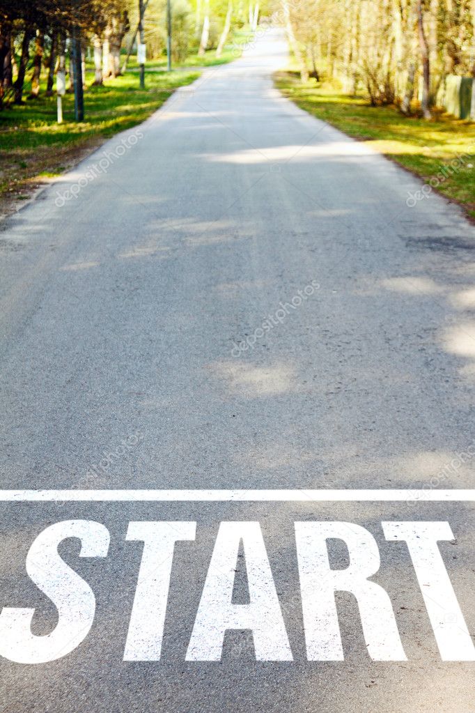 asphalt road with white start sign