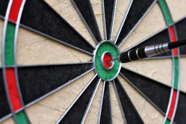 Dartboard with dart in the center — Stock Photo, Image