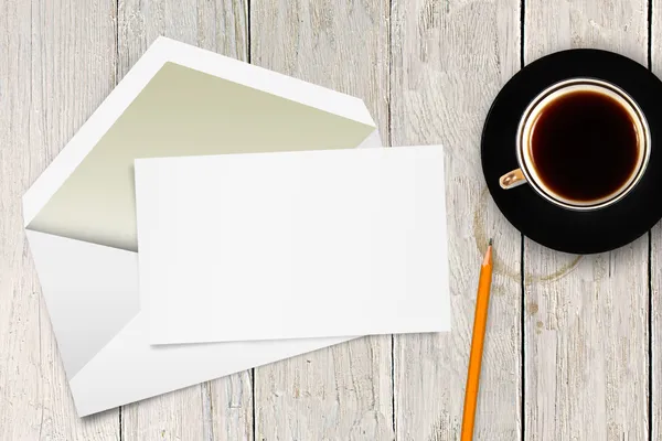 Carta en blanco con sobre y taza de café sobre la mesa —  Fotos de Stock