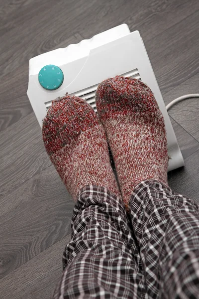 Feet with wool socks and electric heater — Stock Photo, Image