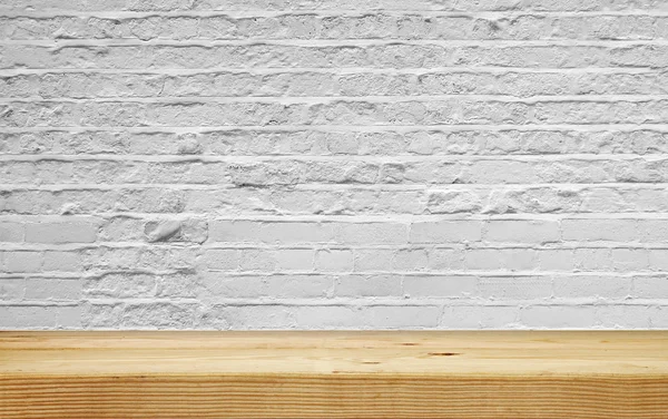 Empty shelf on white brick wall — Stock Photo, Image